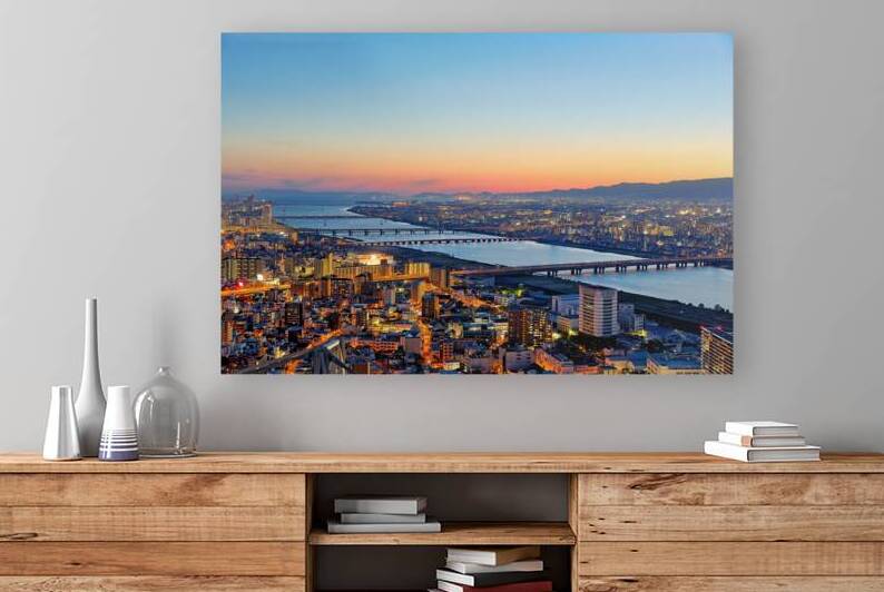 View of Yodo river in Osaka at sunset with city structures and r by Marco Brivio