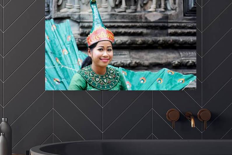 Smiling Cambodian dancer in traditional peacock costume at templ by Marco Brivio