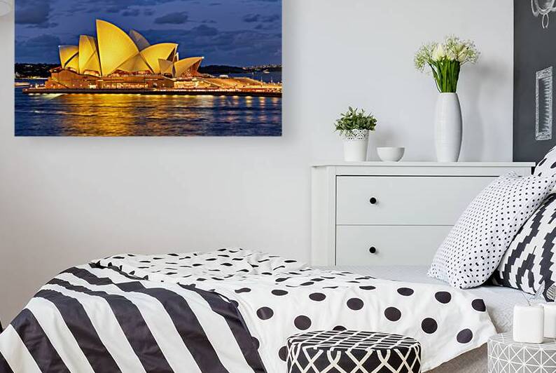 Sydney Opera House illuminated at dusk with harbor lights. by Marco Brivio