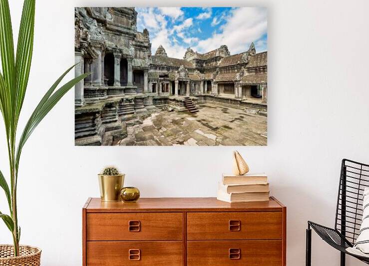 Ancient Angkor Wat temple complex under a blue sky. by Marco Brivio