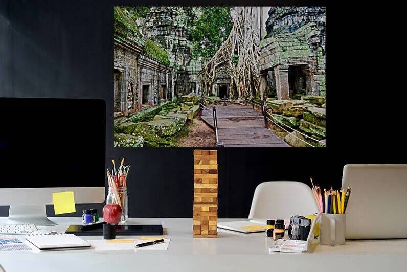 Massive tree roots engulf ancient temple ruins with moss. by Marco Brivio