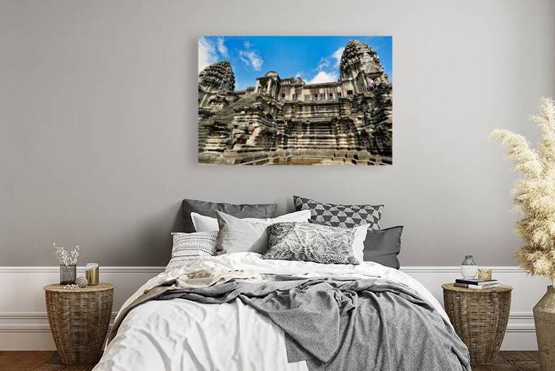 Ancient Angkor Wat temple with tourists under blue sky by Marco Brivio