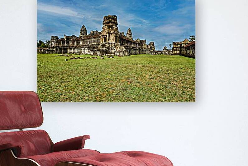 Angkor Wat temple complex with green grass and blue sky. by Marco Brivio