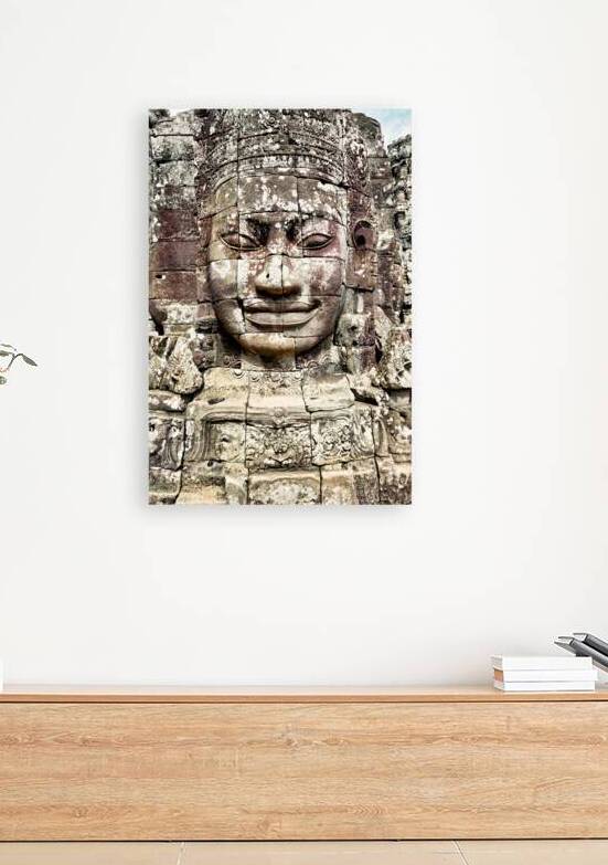 Ancient stone face carving at Bayon temple Cambodia. by Marco Brivio