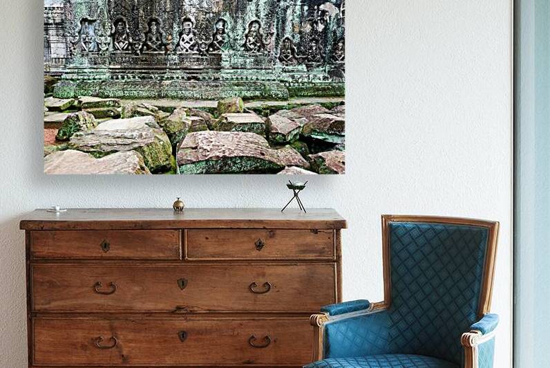 Ancient temple wall carvings and fallen stones covered in moss. by Marco Brivio