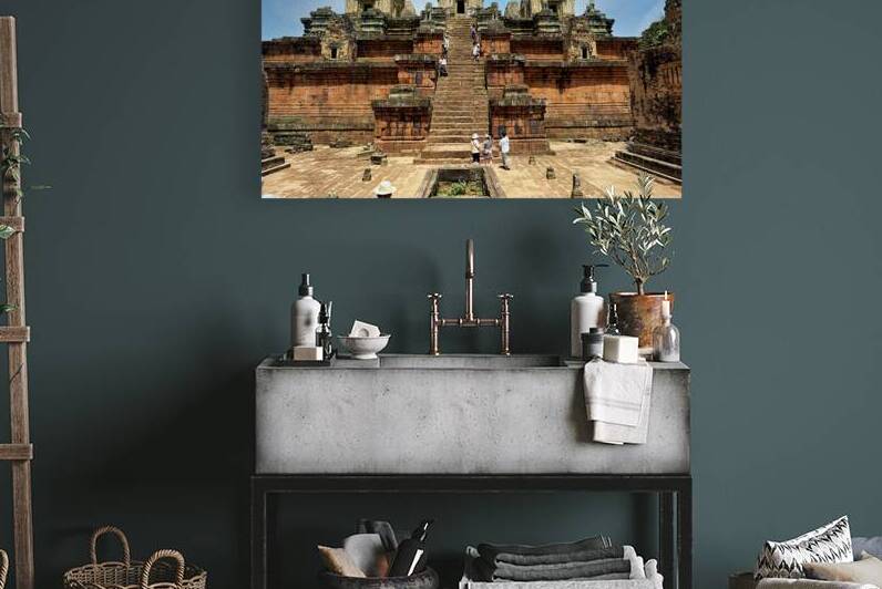 Tourists explore ancient Cambodian temple ruins. by Marco Brivio