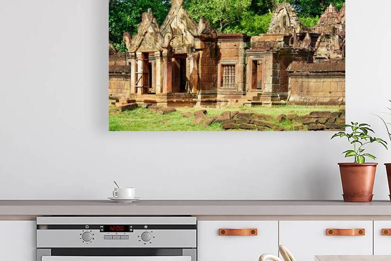 Ancient Banteay Srei temple ruins with intricate carvings and gr by Marco Brivio