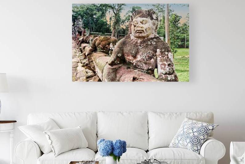 Ancient stone guardian statue at temple entrance. by Marco Brivio