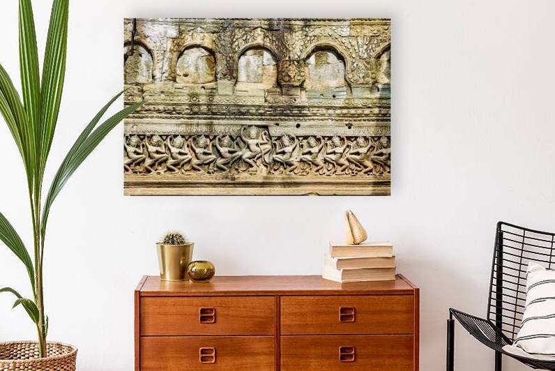 Ancient Khmer temple wall with dancing Apsara bas reliefs. by Marco Brivio