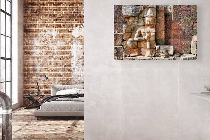 Ancient Khmer stone carving on a weathered temple wall. by Marco Brivio