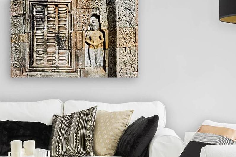 Ancient temple wall with intricate stone carvings and a figure. by Marco Brivio