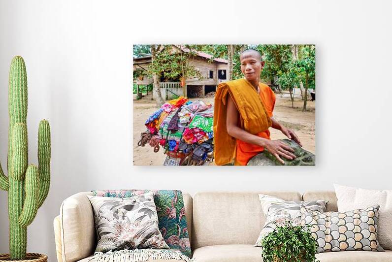 Monk with colorful textiles on a motorcycle. by Marco Brivio