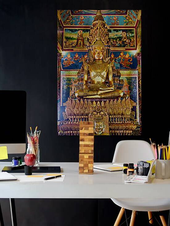 Ornate golden Buddha statue surrounded by colorful temple murals by Marco Brivio