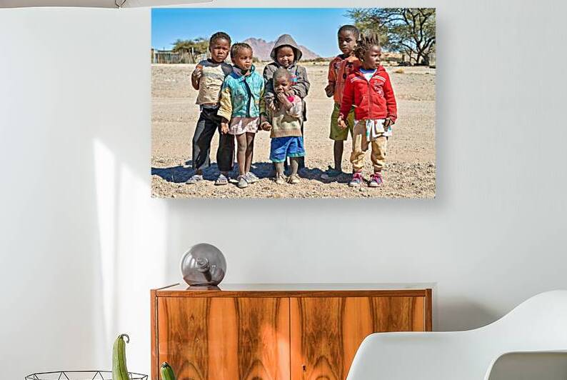 Group of children stand together in Damaraland Namibia village by Marco Brivio
