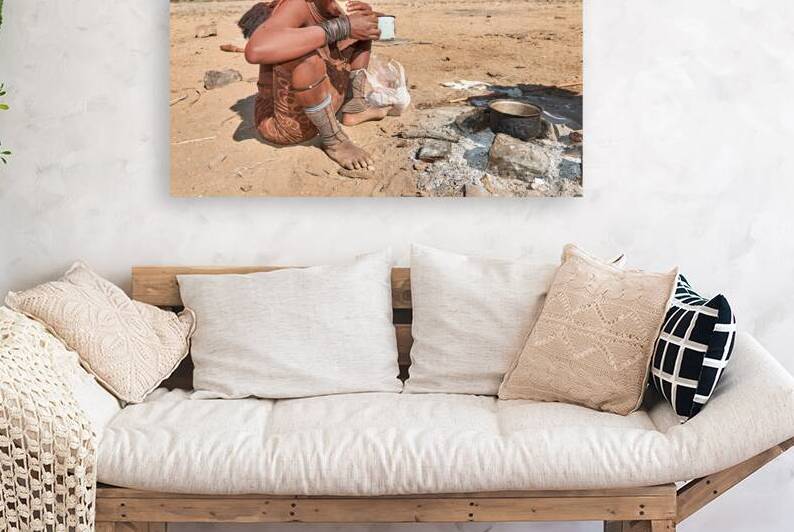 Himba woman enjoying bread in Kunene region of Namibia by Marco Brivio