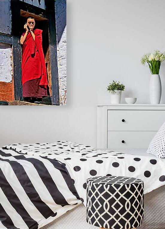 Monk in red robes on cell phone. by Marco Brivio