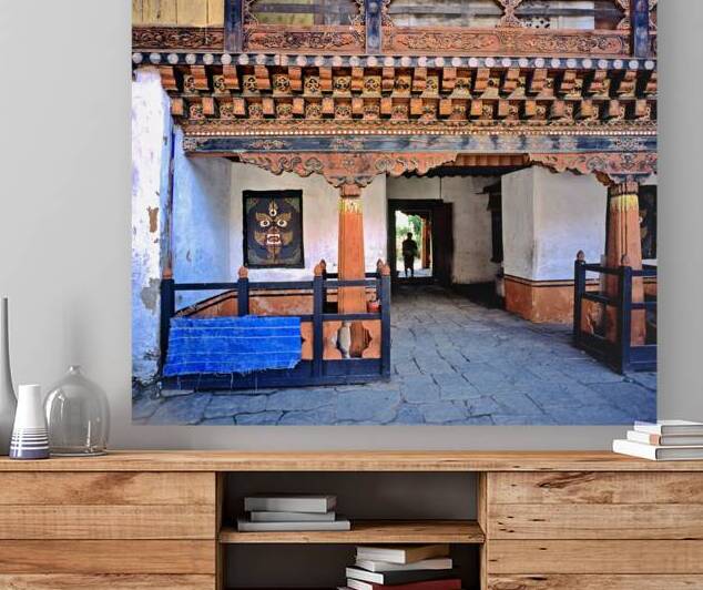 Intricate Bhutanese temple entrance with a person and fierce mas by Marco Brivio