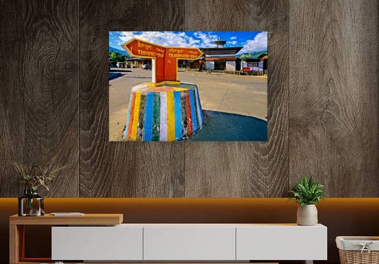 Colorful Bhutanese signpost directs to Thimphu and Trashigang. by Marco Brivio