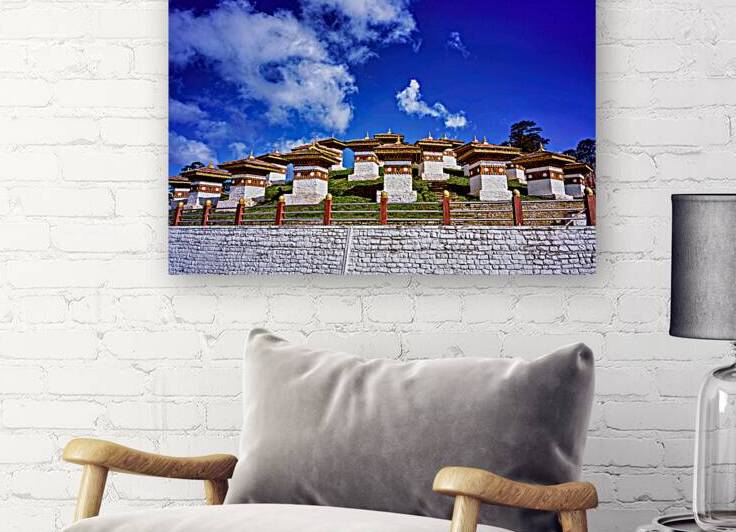Traditional Bhutanese chortens on a green hill blue sky. by Marco Brivio