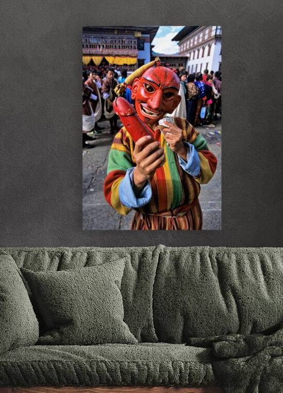 Masked figure holding phallus at a Bhutanese festival. by Marco Brivio