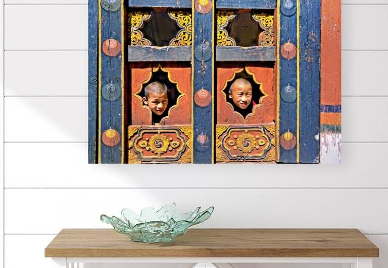 Young monks peeking from decorative colorful windows. by Marco Brivio