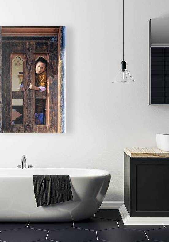 Bhutanese child peeking from ornate wooden window. by Marco Brivio