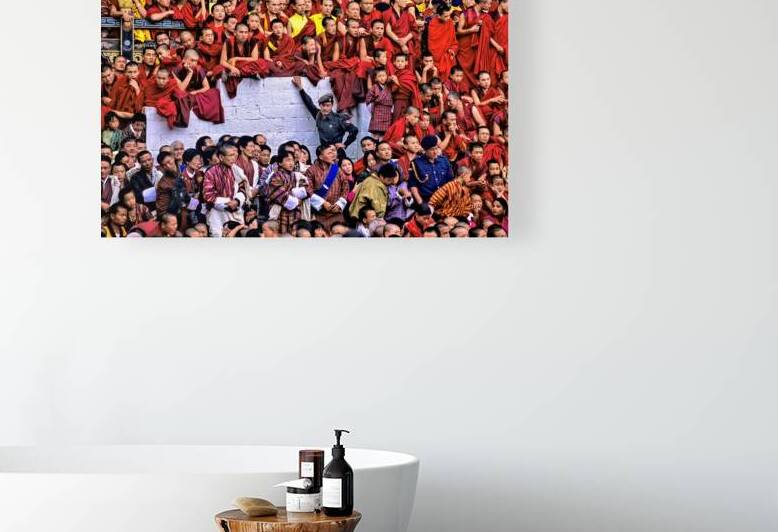 Monks and people observe a traditional Bhutanese ceremony. by Marco Brivio