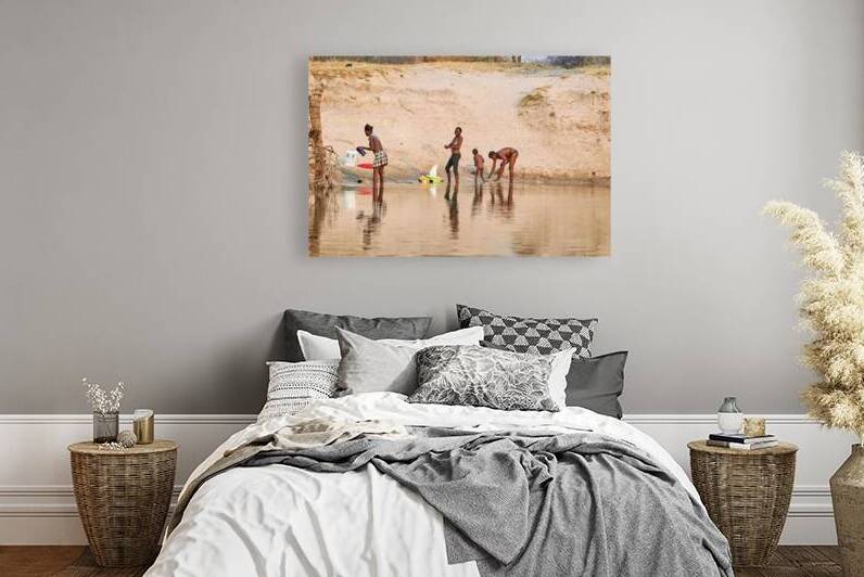 People wash clothes on the banks of the Okavango river in Namibi by Marco Brivio