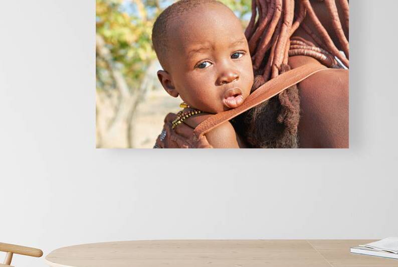 Portrait of Himba woman carrying baby in Kunene region Namibia by Marco Brivio