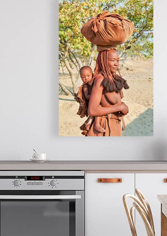 Himba woman carries baby in Kunene region of Namibia by Marco Brivio