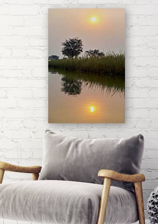 Banks of Okavango River at dusk in Namibia with reflections by Marco Brivio