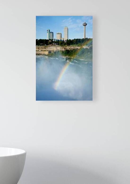 Rainbow over Niagara Falls with city skyline. by Marco Brivio