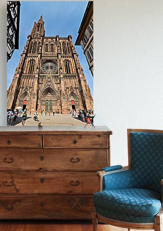 Visitors gather at Strasbourg Cathedral in Alsace under clear sk by Marco Brivio