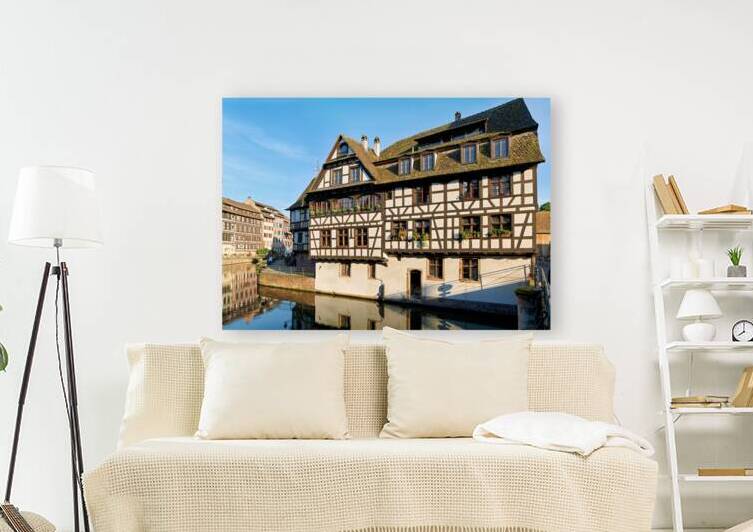 Wooden houses line the canal in Petit France district by Marco Brivio