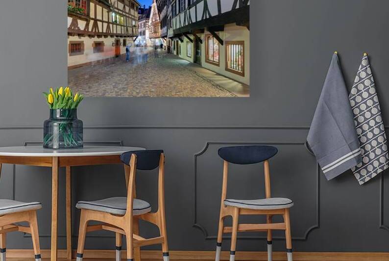 People walk in Petit France district of Strasbourg at dusk by Marco Brivio