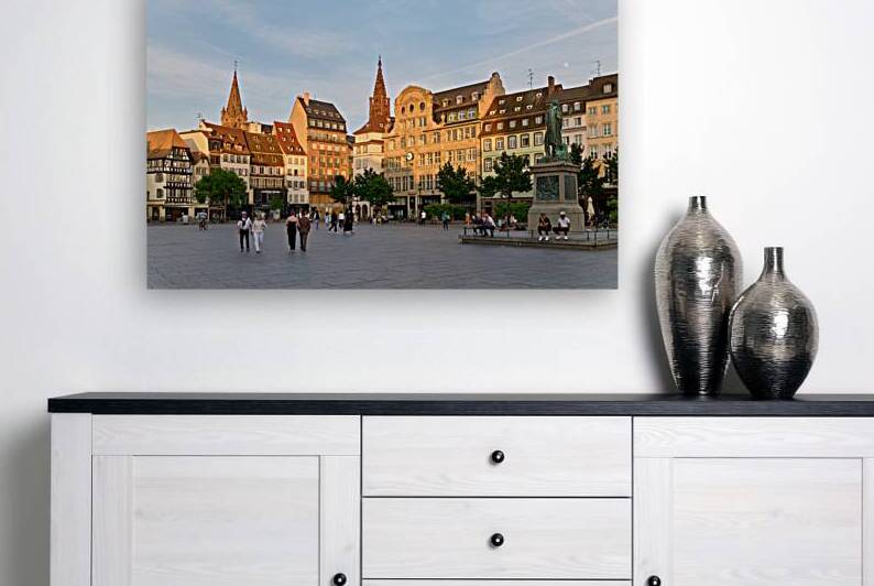 People walk in Place Kleber Strasbourg during the evening glow by Marco Brivio