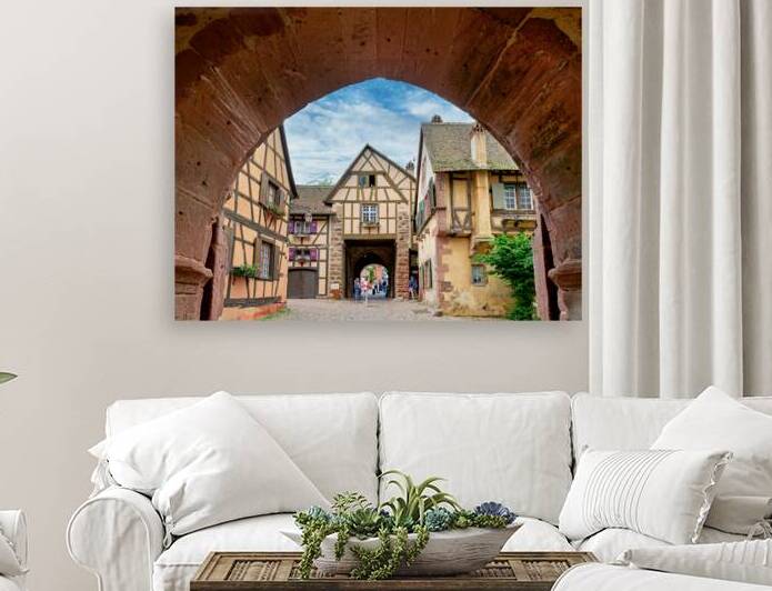 Visitors walk through an archway in Riquewihr by Marco Brivio