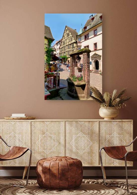 Visitors walk through the streets of Riquewihr in Alsace during  by Marco Brivio