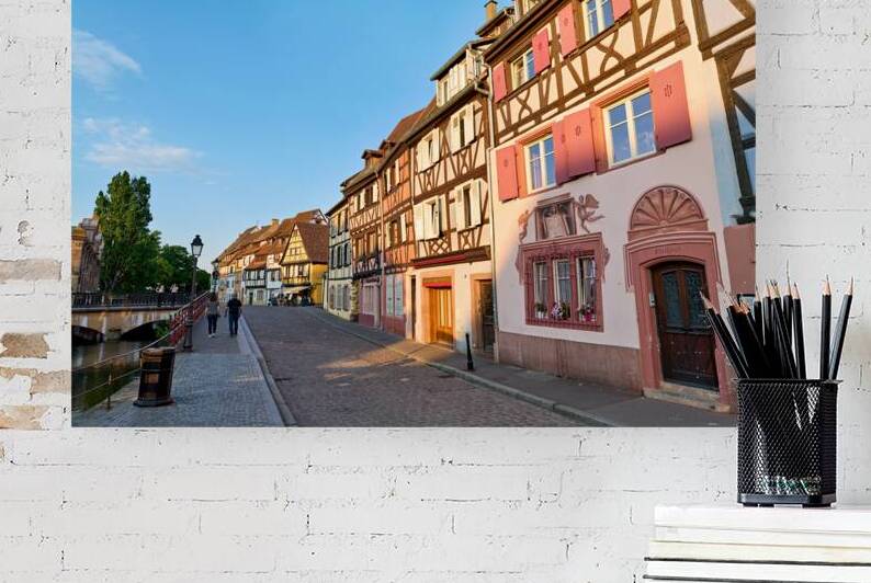 People walking along the canal in Petite Venise Colmar during ev by Marco Brivio