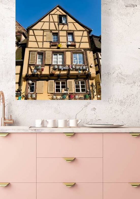 Timber framed houses in Colmar with clear blue sky above by Marco Brivio