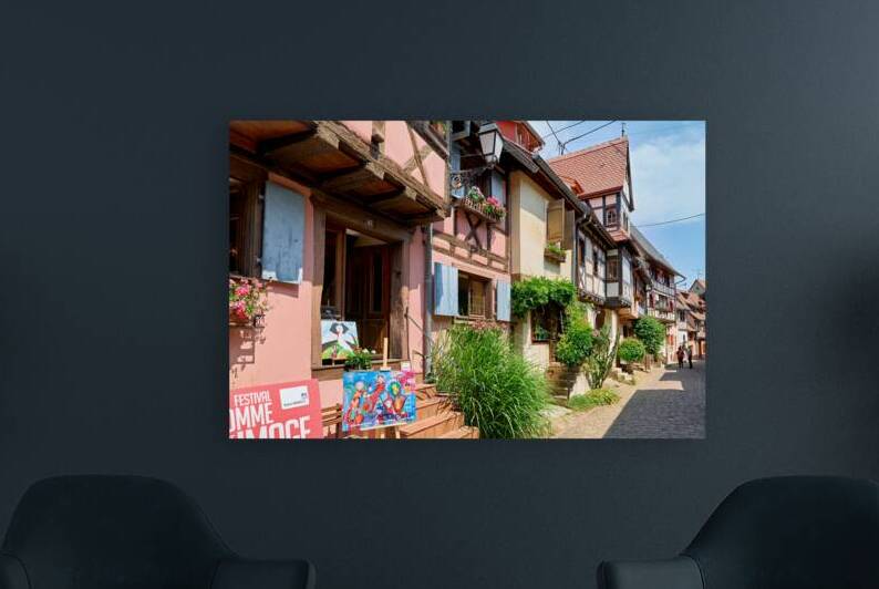 Visitors stroll through Eguisheim on the Alsace Wine Route by Marco Brivio
