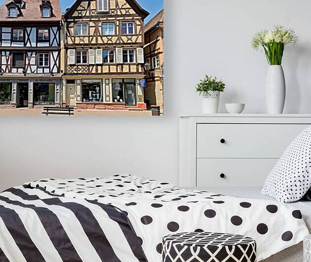 Visitors explore timber framed houses in Colmar Alsace on a sun by Marco Brivio