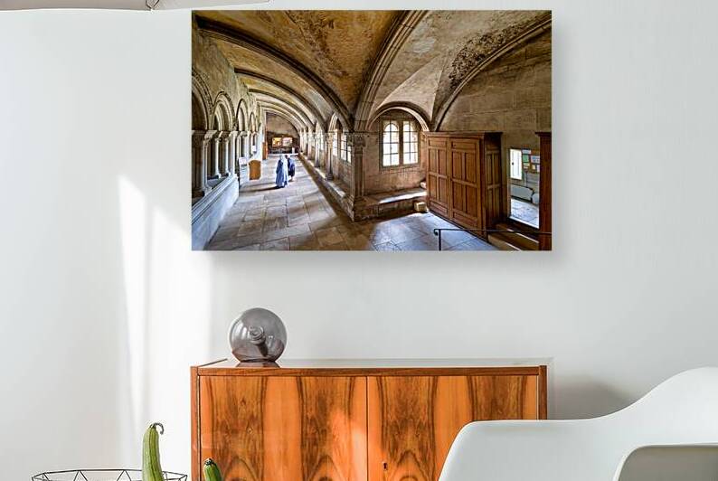 Nun walking in the cloister of Vezelay Abbey in Bourgogne France by Marco Brivio