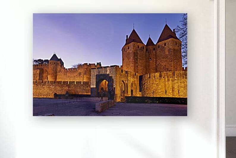 Historic walls of Carcassonne glow at dusk in France by Marco Brivio