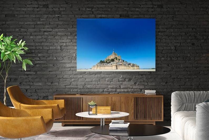 Mont Saint Michel rises above the ground during low tide in Norm by Marco Brivio