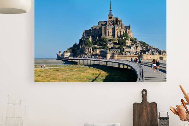 Tourists walking along the path to Mont Saint Michel in Normandy by Marco Brivio