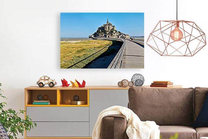 Tourists walking on bridge to Mont Saint Michel in Normandy Fran by Marco Brivio