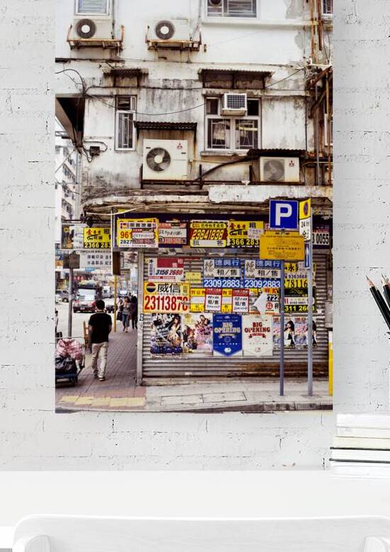 Busy street in Hong Kong shows old building and pedestrians by Marco Brivio