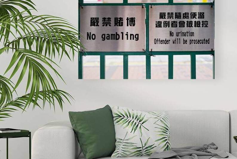 Signs against gambling and public urination in Hong Kong alley by Marco Brivio