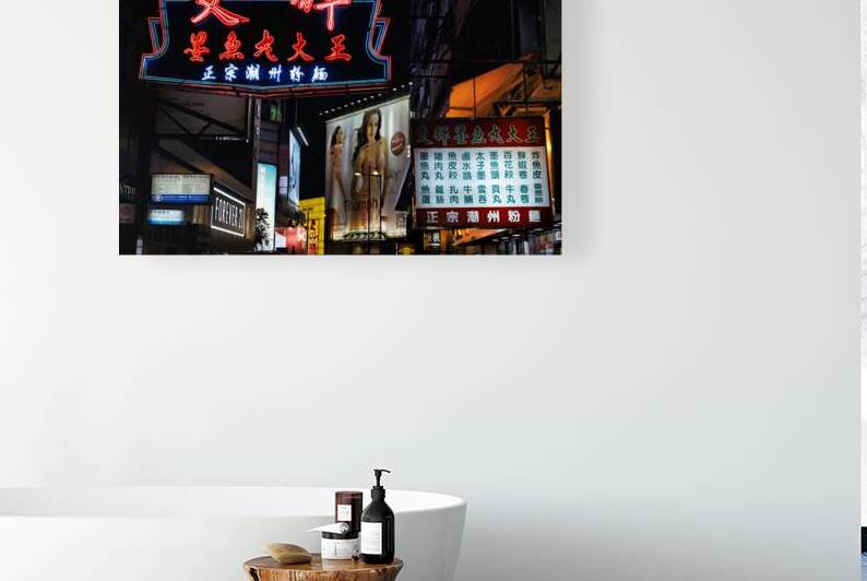 Neon signs light up a busy street in Hong Kong at night by Marco Brivio